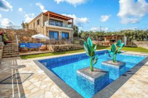 a villa with a swimming pool and a house at Villa Elea with Private Pool in Zakynthos