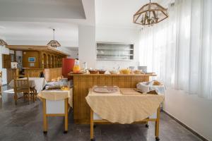a kitchen with a table and a dining room at Kamari Blue Boutique Hotel in Kamari