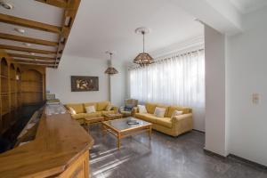 a living room with couches and a table at Kamari Blue Boutique Hotel in Kamari