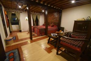 a room with a bedroom with a bed and a table at Temple House in Kathmandu