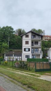 a white building with a fence in front of it at Miris Dunava 2 in Golubac