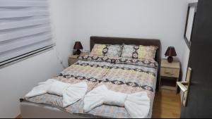 a bedroom with a bed with two pillows on it at Miris Dunava 2 in Golubac