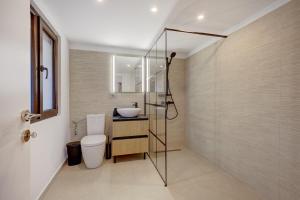 a bathroom with a toilet and a sink at Forest House Premium Breaza in Breaza de Sus +50 photos