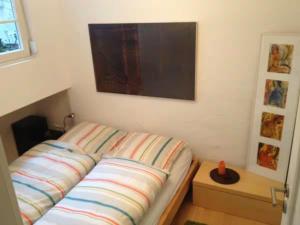 a small bedroom with a bed with avertisement at Zum oberen Schulhof in Konstanz