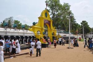 a group of people standing in front of a yellow building at Hotel Camorich in Tissamaharama