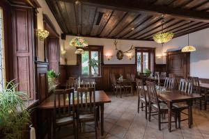 a dining room with wooden tables and chairs at Hotel Karwendelblick in Urfeld