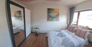 a bedroom with a bed and a large window at ChristRose in Trechtingshausen