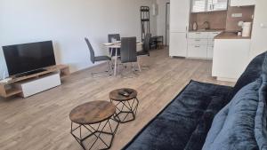 a living room with a couch and a table and a kitchen at 3-room apartment in Trnava