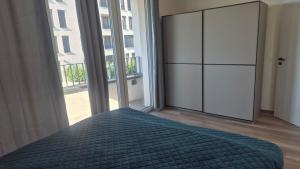 a bedroom with a bed and a large window at 3-room apartment in Trnava