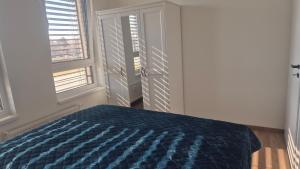 a bedroom with a bed and two windows at 3-room apartment in Trnava
