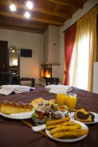 a table with a plate of food and fruit on it at Hotel Edem in Kato Loutraki