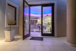an open door to a room with a patio at La Mer Deluxe Hotel & Spa in Kamari