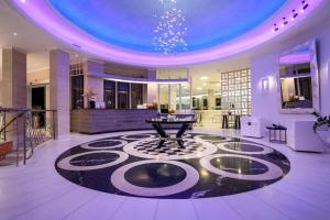 a lobby with a table in the middle of a room at La Mer Deluxe Hotel & Spa in Kamari