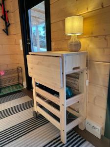 a table with a lamp on top of it at Sauna by Lake Saimaa in Savonlinna