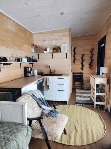 a kitchen with a counter and a chair in a room at Sauna by Lake Saimaa in Savonlinna