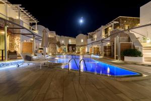 a pool in the middle of a house at night at La Mer Deluxe Hotel & Spa in Kamari