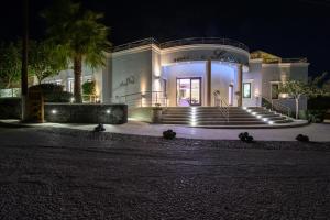 a building with stairs in front of it at night at La Mer Deluxe Hotel & Spa in Kamari