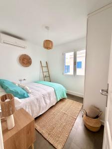 a bedroom with a bed and a mirror at Famara ocean view house in Famara
