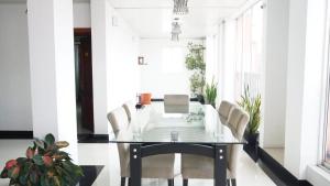 a dining room with a glass table and chairs at The Residence Dambulla in Dambulla