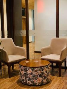 two chairs and a coffee table in a room at The Residence Dambulla in Dambulla