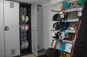 a room with skis and snowboards on a shelf at Casa Olivati in Pellizzano