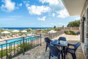 a patio with a table and chairs next to a pool at Villa Elea with Private Pool in Zakynthos