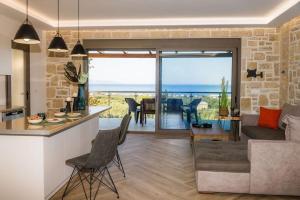a kitchen and living room with a view of the ocean at Villa Elea with Private Pool in Zakynthos