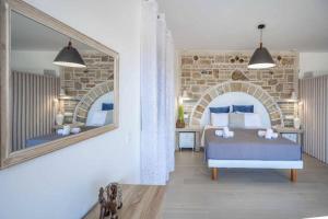 a bedroom with a bed and a mirror at Villa Elea with Private Pool in Zakynthos +46 photos