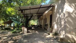 a wooden pergola on the side of a building at Corbett Green Orchard in Rāmnagar
