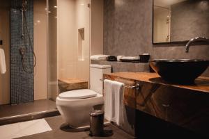a bathroom with a toilet and a sink and a shower at RakYim Siam - Sukhumvit 15 in Bangkok +99 photos