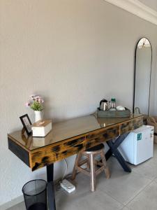 a wooden desk in a room with a mirror at Sebeshong Guest House - Moletjie in Ga-Komape