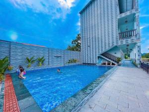 a pool at a hotel with people in it at New Day Homestay in Ninh Binh