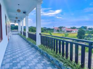 a balcony of a house with a walkway at New Day Homestay in Ninh Binh