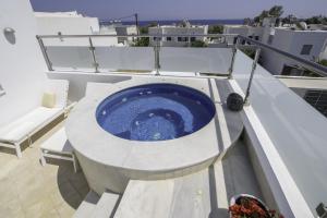 a large blue tub on the top of a building at La Mer Deluxe Hotel & Spa in Kamari