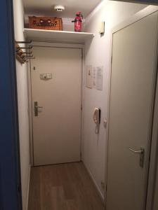 
a door is open to a small room with a refrigerator at Studio Oostende Budget in Ostend

