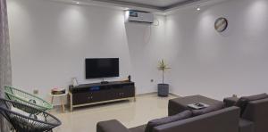 a living room with a flat screen tv on a wall at Bilene Harmony Home in Vila Praia Do Bilene