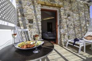 a room with a table with a plate of food at La Mer Deluxe Hotel & Spa in Kamari