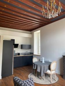a dining room with a table and a kitchen at Maison Léopoldine 1 , Quartier Historique in Blois