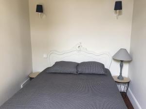 a bed in a bedroom with two pillows on it at Maison Léopoldine 1 , Quartier Historique in Blois