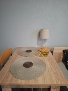 a wooden table with two large mats on top of it at Dārza Studija in Limbaži
