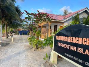 a school textbook sign in front of a building at Samudra Beach Chalet in Perhentian Islands