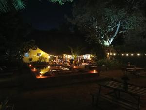 a night view of a patio with a table and lights at 30 Wilson in Jinja