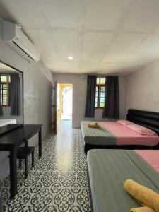 a room with two beds and a desk and a piano at Samudra Beach Chalet in Perhentian Islands +27 photos