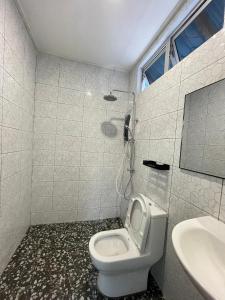 a bathroom with a toilet and a sink at Samudra Beach Chalet in Perhentian Islands