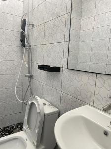 a bathroom with a toilet and a sink and a mirror at Samudra Beach Chalet in Perhentian Islands