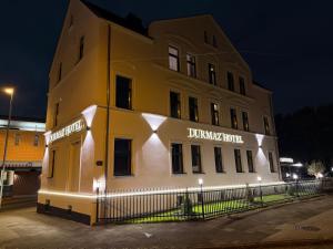 a large yellow building with a sign on it at Durmaz Hotel in Hannover