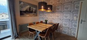 a dining room with a wooden table and chairs at Apartmenthaus Hinterer in Bad Goisern