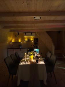 a dining room with a table with chairs and lights at Uptown Batumi Yard & Jacuzzi in Batumi