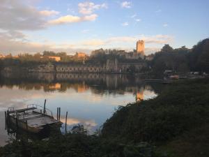 a boat on a lake with a castle in the background at Leo House in Trezzo sullʼAdda +32 photos
