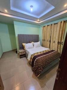 a bedroom with a bed in a room at G and E Guesthouse in Kumba